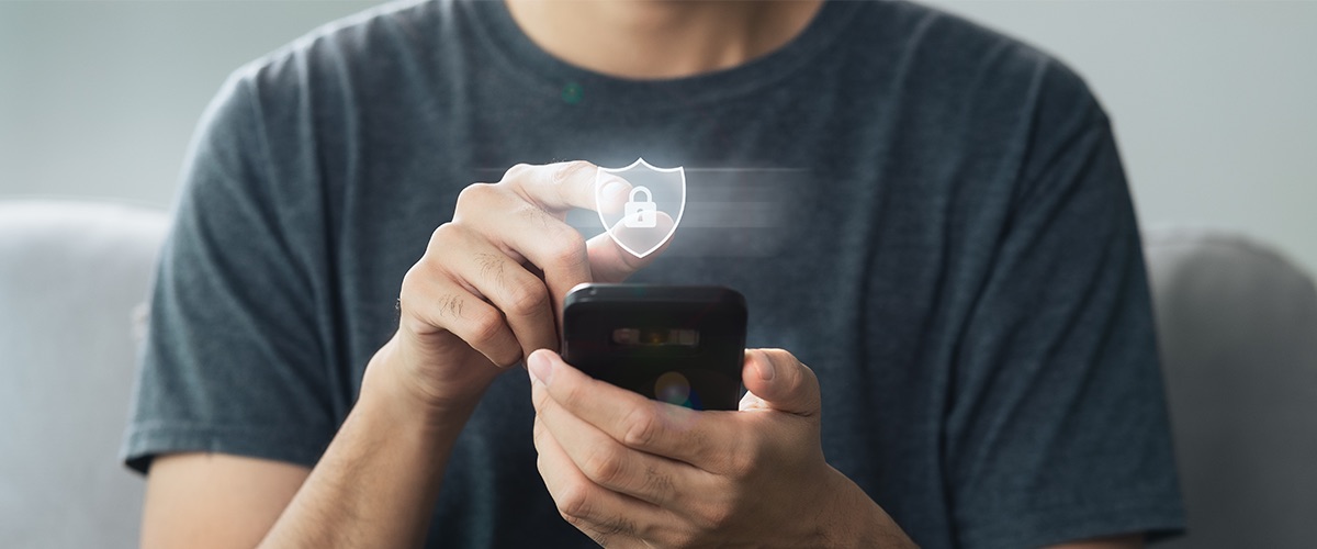 Persona haciendo un pago desde el teléfono con un icono de seguridad